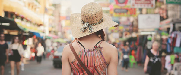 Woman walking down a busy city street